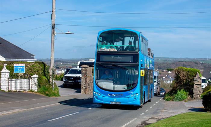 an open-top bus driving along a road